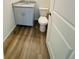 Bathroom with wood-look flooring, light gray vanity, and granite countertop at 45016 Sunflower Ln, Bennett, CO 80102