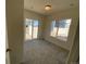 A carpeted bedroom featuring natural light from sliding glass door and a window at 45016 Sunflower Ln, Bennett, CO 80102
