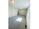 Bright bedroom with gray carpeting, a bathroom entrance, and natural light at 45016 Sunflower Ln, Bennett, CO 80102