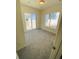 A carpeted bedroom featuring natural light from sliding glass door and a window at 45016 Sunflower Ln, Bennett, CO 80102