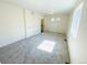 Inviting bedroom with gray carpeting, natural light, and attached bathroom at 45016 Sunflower Ln, Bennett, CO 80102