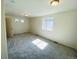 Spacious bedroom with natural light and plush gray carpeting at 45016 Sunflower Ln, Bennett, CO 80102