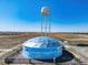 Unique town water tower with an artful welcome neighbors message in a beautiful landscape at 45016 Sunflower Ln, Bennett, CO 80102