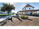 Charming Bennett welcome center with a covered porch and rocking chairs, set in a landscaped area at 45016 Sunflower Ln, Bennett, CO 80102