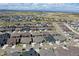 A beautiful aerial view showcases a well-planned community with uniform homes and scenic mountain backdrop at 1962 Canyonpoint Ln, Castle Pines, CO 80108