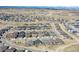 Aerial view showcasing a well-planned community with uniform homes and scenic mountain backdrop at 1962 Canyonpoint Ln, Castle Pines, CO 80108