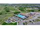 An aerial view of a community pool, playground, and recreation center surrounded by green space and walking trails at 1962 Canyonpoint Ln, Castle Pines, CO 80108