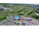 An aerial view of a community pool, playground, and recreation center surrounded by green space and walking trails at 1962 Canyonpoint Ln, Castle Pines, CO 80108