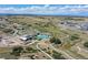 Aerial view of a community showcasing the pool and community center, natural landscape, and walking trails at 1962 Canyonpoint Ln, Castle Pines, CO 80108