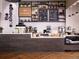 Coffee shop with white brick walls, shelving filled with plants, and a counter with coffee-making equipment at 1962 Canyonpoint Ln, Castle Pines, CO 80108