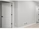 Hallway with white doors and trim, with neutral walls and carpet for a clean aesthetic at 1962 Canyonpoint Ln, Castle Pines, CO 80108