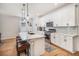 Beautiful kitchen with white cabinets, quartz countertop island, stainless appliances, and wood flooring at 1962 Canyonpoint Ln, Castle Pines, CO 80108