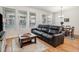 Comfortable living area with a leather sofa, wooden coffee table, and a dining table near a door at 1962 Canyonpoint Ln, Castle Pines, CO 80108