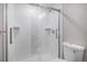 Contemporary glass shower with white tiled surround, complemented by modern fixtures for a spa-like experience at 1962 Canyonpoint Ln, Castle Pines, CO 80108
