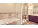 Bright bathroom with separate tub and shower with glass door at 1630 N Clarkson St # 204, Denver, CO 80218