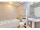 Cozy bathroom with tub, sink, toilet, and above-toilet storage at 1630 N Clarkson St # 204, Denver, CO 80218