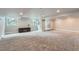 Spacious basement area with ample natural light, neutral carpet, and walkout at 19098 E Ida Dr, Aurora, CO 80015