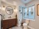 Chic bathroom with modern vanity, stylish lighting, and hanging plants near the window at 19098 E Ida Dr, Aurora, CO 80015
