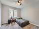 Cozy bedroom featuring carpeting, a ceiling fan, and a full bed with bedside table and lamp at 19098 E Ida Dr, Aurora, CO 80015