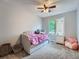 Bright bedroom with a daybed, soft carpet, and a window offering natural light at 19098 E Ida Dr, Aurora, CO 80015