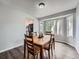Dining room with a wooden table, chairs, dark wood-style flooring, and a large bay window at 19098 E Ida Dr, Aurora, CO 80015
