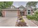 Charming two-story home with brick accents, a two-car garage, and beautiful landscaping at 19098 E Ida Dr, Aurora, CO 80015