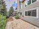 Exterior elevation of the home highlighting a patio and well-maintained landscaping at 19098 E Ida Dr, Aurora, CO 80015