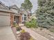 Charming two-story home with brick accents and a beautifully landscaped front yard with walkway at 19098 E Ida Dr, Aurora, CO 80015