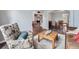 Bright living area featuring wood floors, a floral arm chair, and views to the entry, dining and stairwell at 19098 E Ida Dr, Aurora, CO 80015