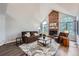 Cozy living room with a brick fireplace, vaulted ceilings, and abundant natural light at 19098 E Ida Dr, Aurora, CO 80015