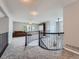 Spacious loft area featuring carpeting, railing, a couch, and an entertainment area at 19098 E Ida Dr, Aurora, CO 80015