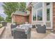 Rear brick patio with outdoor furniture and well manicured landscaping at 19098 E Ida Dr, Aurora, CO 80015