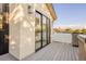 Modern balcony featuring sliding glass doors and sleek exterior lighting, offering a private outdoor space at 2060 Eliot St, Denver, CO 80211
