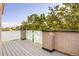 Balcony with brick trim and privacy glass offering an ideal space for outdoor entertaining with great views at 2060 Eliot St, Denver, CO 80211