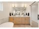 Luxurious bathroom with dual sink vanity, modern lighting, and a glass-enclosed shower, creating a spa-like experience at 2060 Eliot St, Denver, CO 80211