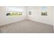 Bright bedroom featuring large windows and plush carpeting, perfect for relaxation at 2060 Eliot St, Denver, CO 80211