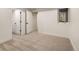 This bright bedroom features neutral carpet, a window and white doors to closets and other rooms at 2060 Eliot St, Denver, CO 80211