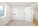 A spacious bedroom with natural light, closet and storage solutions, all in pristine white at 2060 Eliot St, Denver, CO 80211
