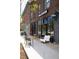 This exterior shot of a coffee shop features outdoor seating and large windows at 2060 Eliot St, Denver, CO 80211