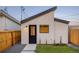 This exterior shows a modern design with unique architectural elements, and includes a patch of grass and gravel at 2060 Eliot St, Denver, CO 80211