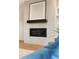Stylish fireplace with tile surround, offering a focal point in the modern living space at 2060 Eliot St, Denver, CO 80211
