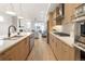 Modern kitchen with stainless steel appliances, custom cabinets, and open floor plan at 2060 Eliot St, Denver, CO 80211