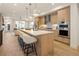 Bright, open kitchen featuring a large island with seating and views into the living space at 2060 Eliot St, Denver, CO 80211