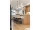 Kitchen island with seating, modern lighting, and an open view of the living area at 2060 Eliot St, Denver, CO 80211