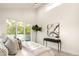 Spacious main bedroom with large windows, balcony access, and a stylish accent table, creating a serene retreat at 2060 Eliot St, Denver, CO 80211