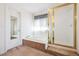 Bright bathroom features a soaking tub and shower with a frosted glass enclosure at 13362 Marion St, Thornton, CO 80241