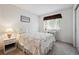 Cozy bedroom with floral comforter, desk, and natural light at 13362 Marion St, Thornton, CO 80241