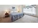 Comfortable bedroom with soft natural light, large window and a cozy bed at 13362 Marion St, Thornton, CO 80241