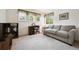 Serene bedroom space furnished with a comfortable couch, desk, and large windows at 13362 Marion St, Thornton, CO 80241