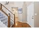 Welcoming foyer with hardwood floors, staircase, and view to the laundry room at 13362 Marion St, Thornton, CO 80241